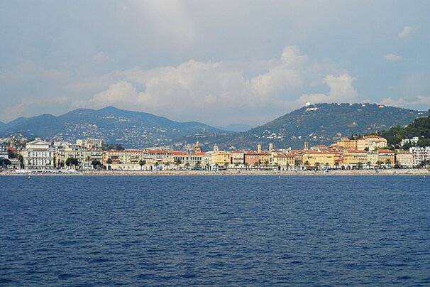 a long beach taken from a distance on a boat